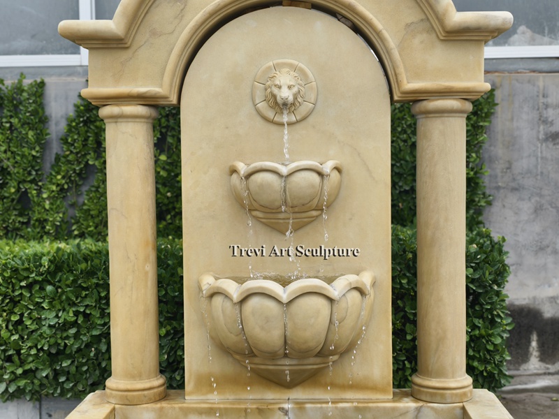 tall stone lion head wall fountain details