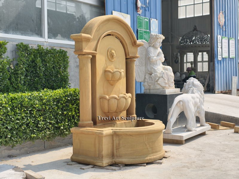tall stone lion head wall fountain