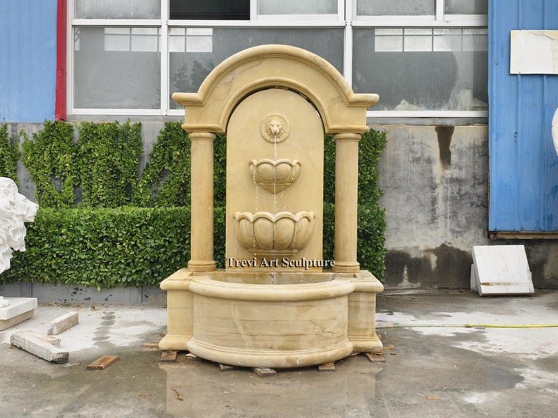 tall stone lion head wall water fountain