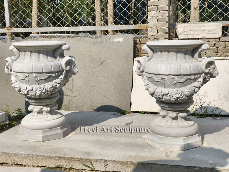 white marble planter with goat relief