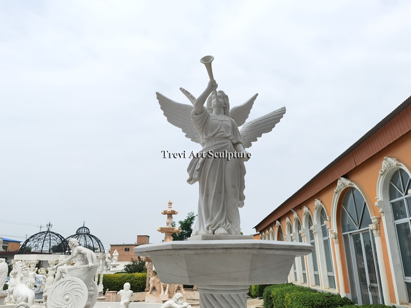 fountain with angel blowing a trumpet statue