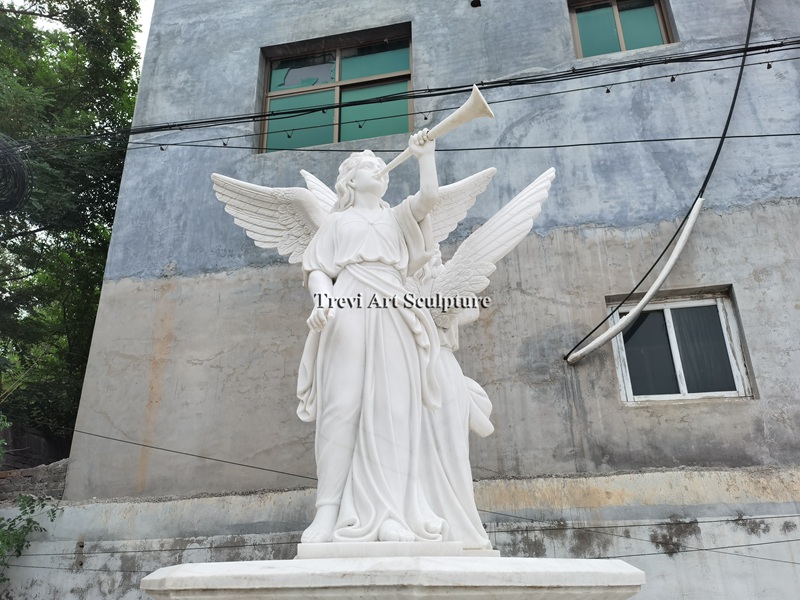 marble fountain with angel blowing a trumpet