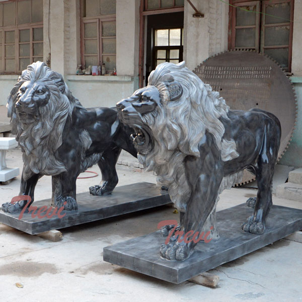 Pair of standing black lions statue in front of house