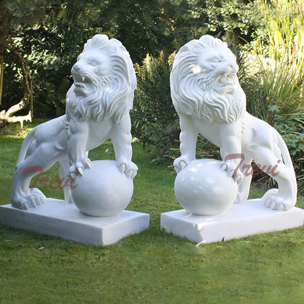 Pair of white marble decorative lion with paw on ball garden statues in front of house