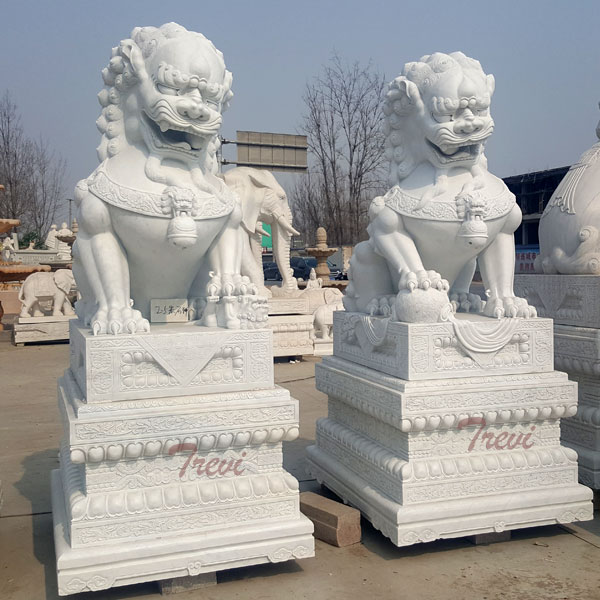 Carved stone lion guardians fu dog pair with base in front of house