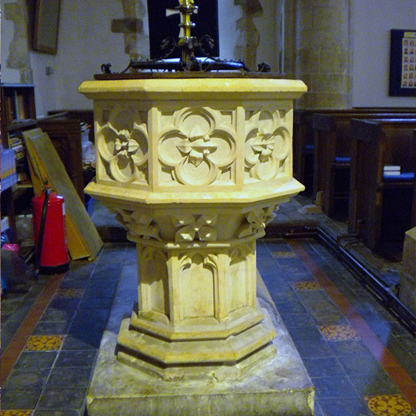 White marble baptismal font for catholic church interior decor