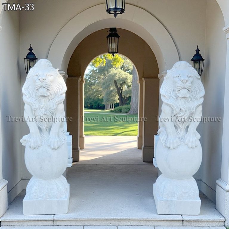pair of lions statue on ball