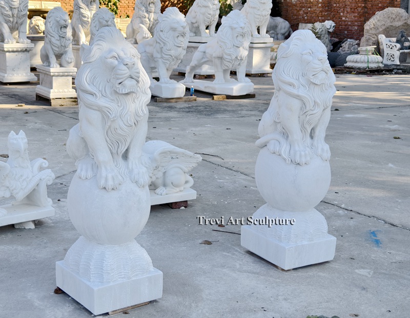 pair of lions statue standing on ball