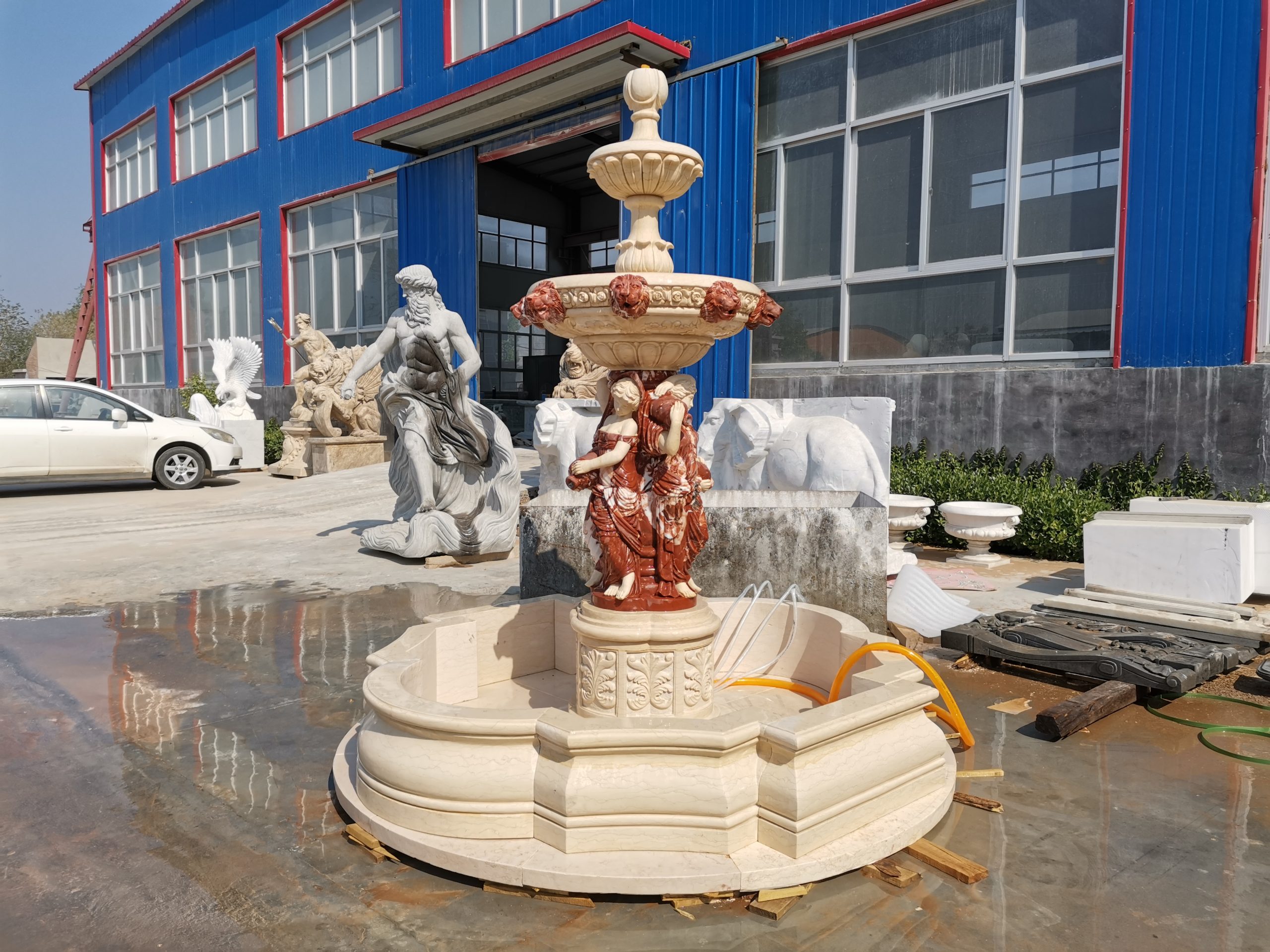beige fountain with maiden sculptures