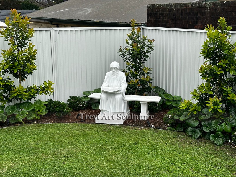 marble st charbel statue sitting on bench feedback