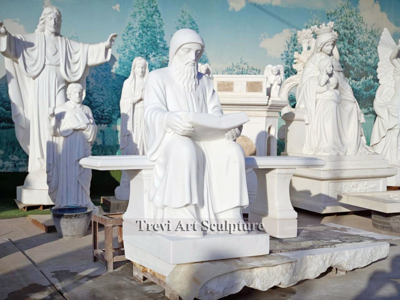 marble st charbel statue sitting on bench