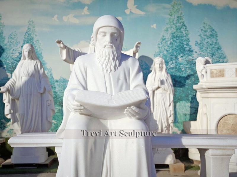 life size marble st charbel statue sitting on bench