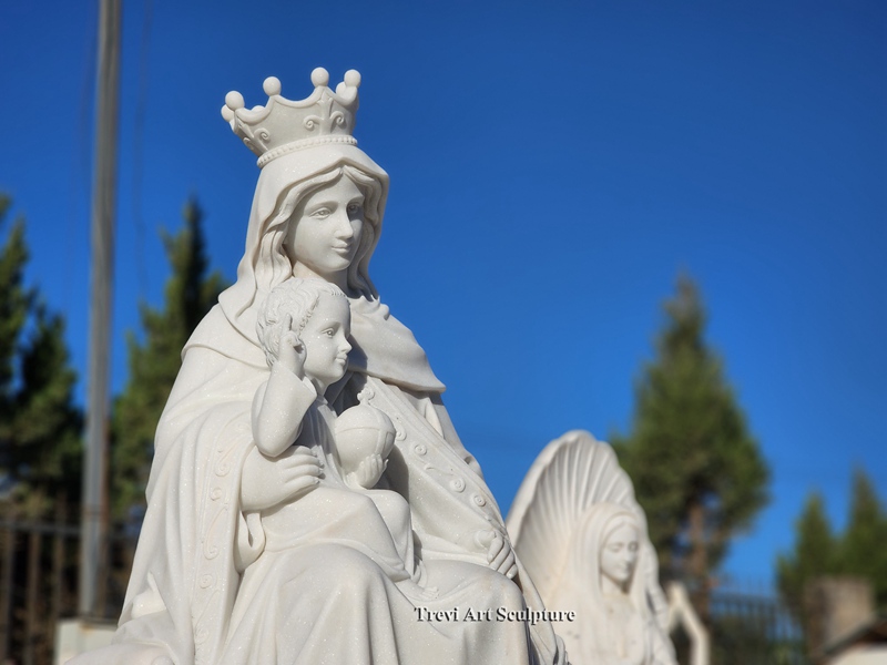 seated sculpture of the virgin mary holding jesus