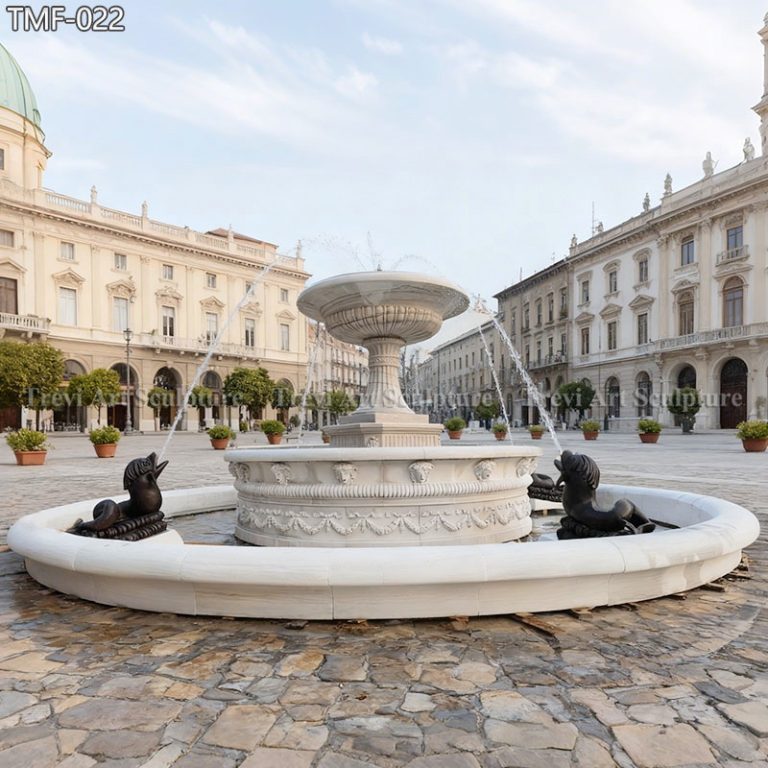 large outdoor fountain with bronze fish statues
