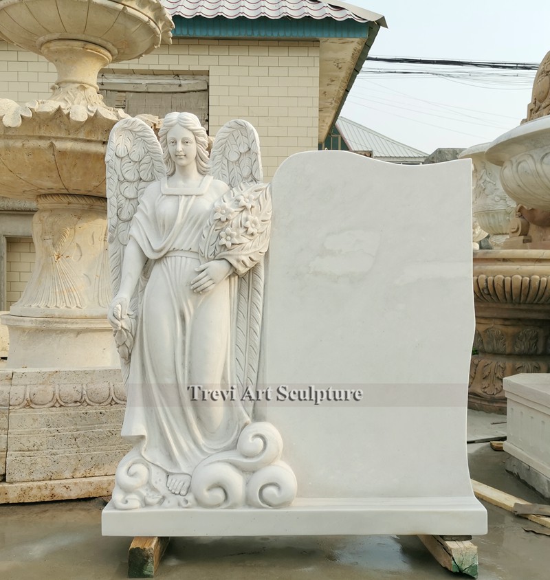 marble standing angel with flower headstone monument
