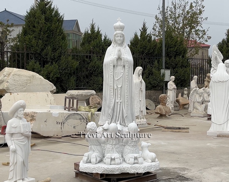 white marble virgin fatima statue with children and lamb