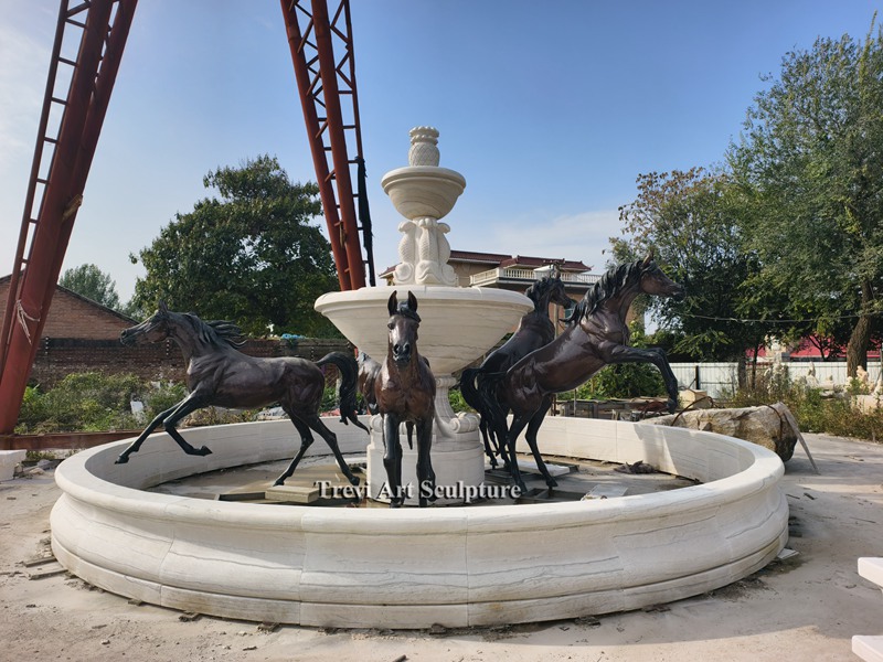 horse fountain with marble pool surround