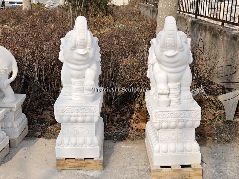 outdoor white elephant statue with trunk up