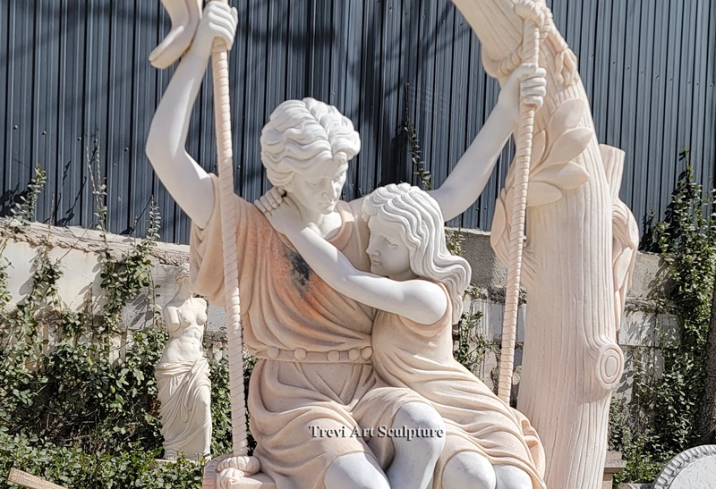 romantic couple on swing sculpture