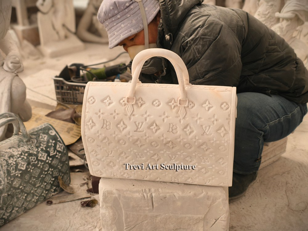 artisan carving white marble handbag sculpture