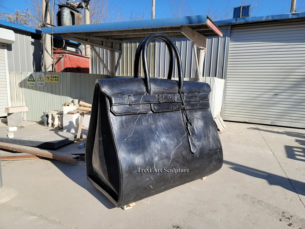 large scale black marble bag sculpture