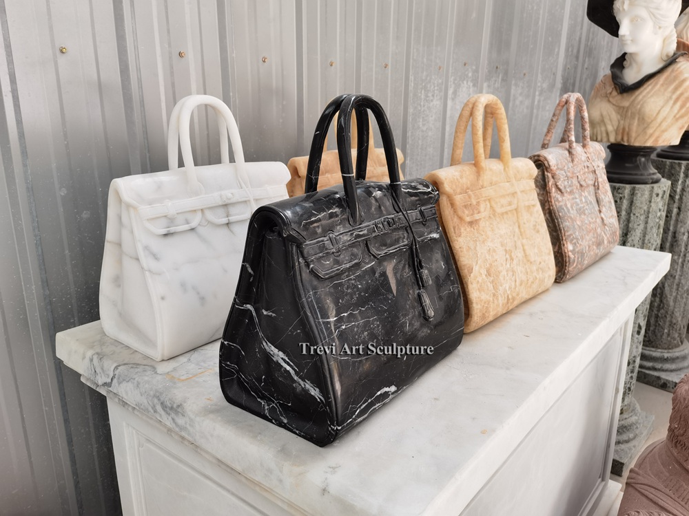 white, black, beige & pink marble stone bags displayed on marble console table