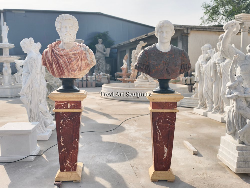 classical marble roman busts set on elegant red marbled pedestals with beige stone accents