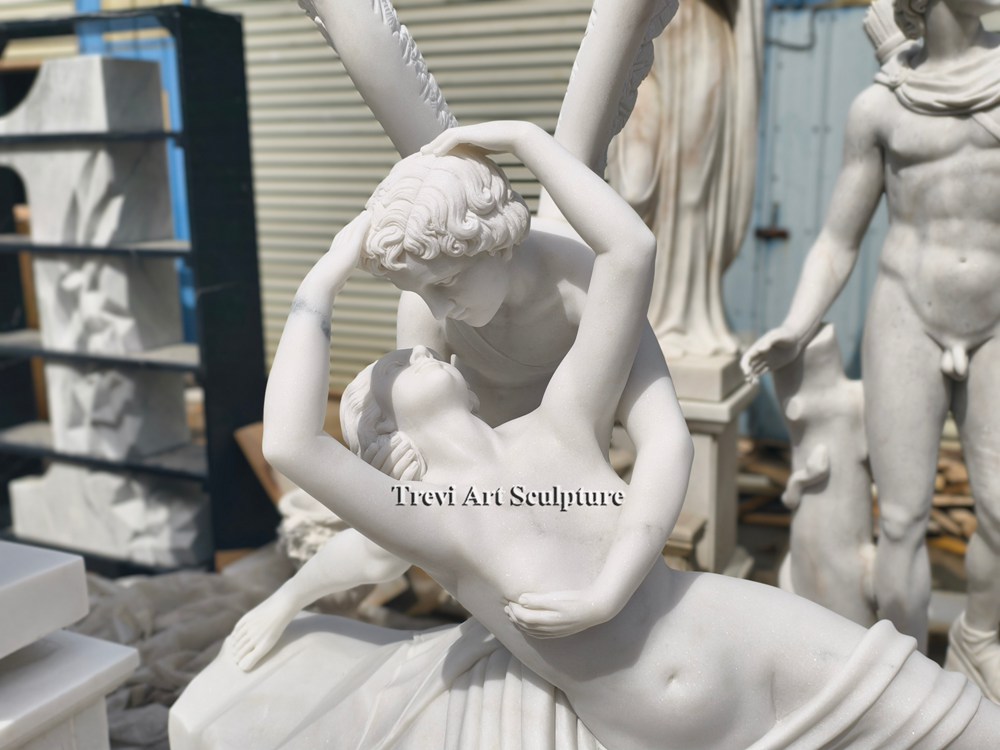 close up detail of the hand carved white marble statue psyche revived by cupid's kiss