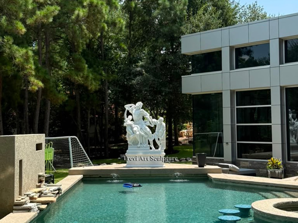 daytime view of the laocoön and his sons marble sculpture positioned by the luxury swimming pool