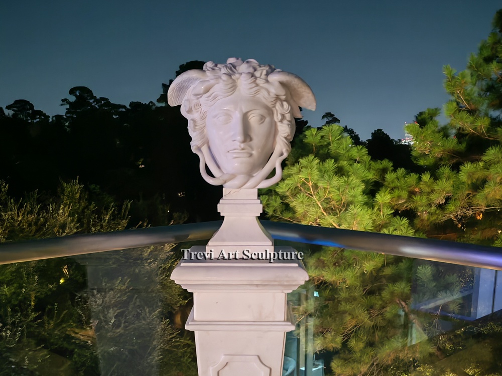 marble medusa bust installed on a balcony