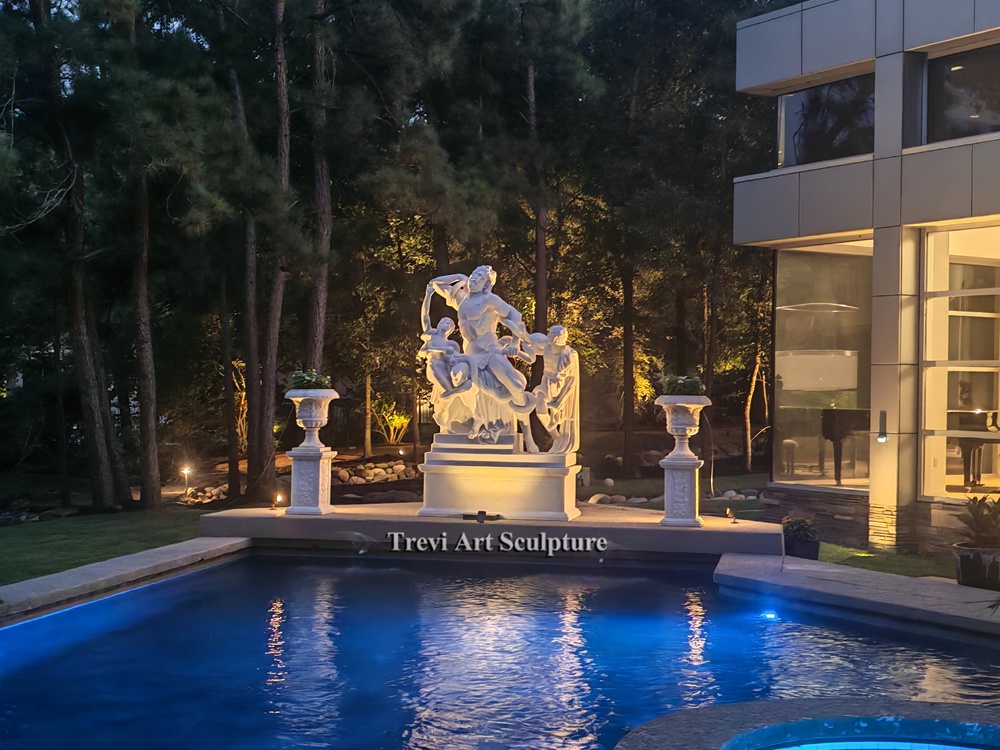 stunning poolside display featuring the laocoön statue and marble urns under evening lights