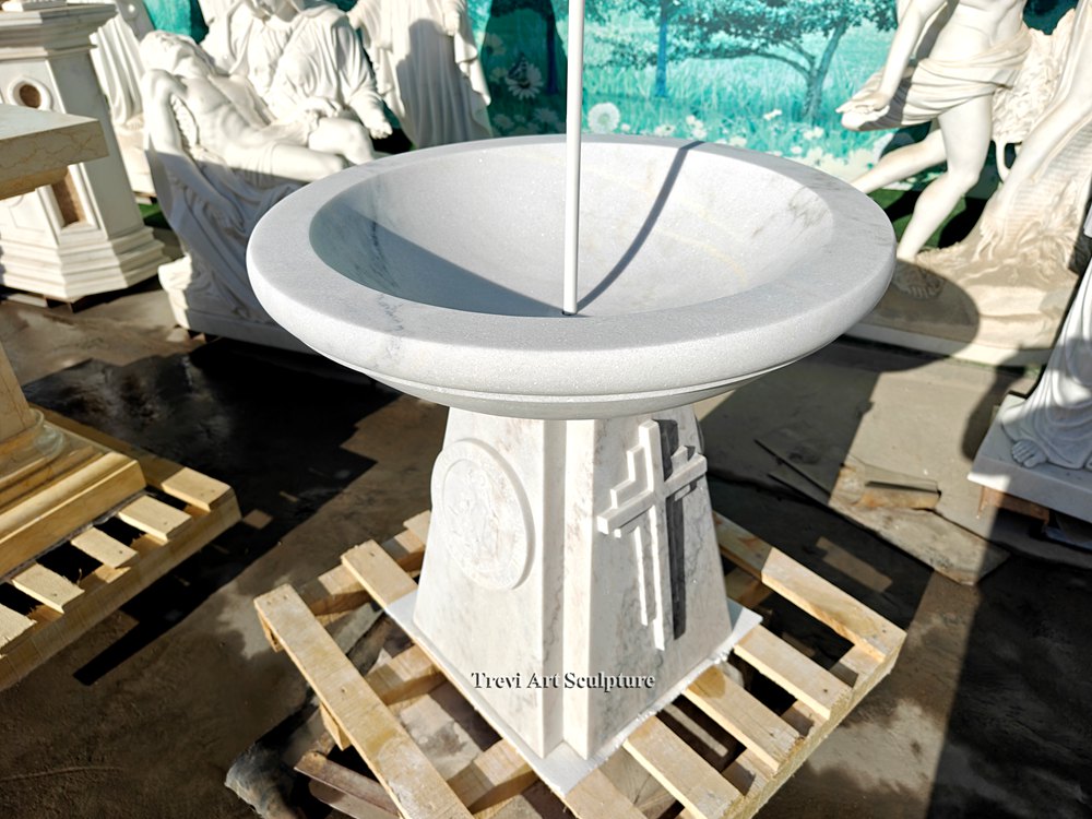 white marble round bowl baptismal font with raised cross